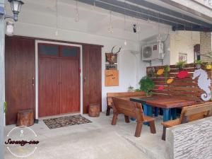 a dining room with a wooden table and benches at 71號民宿 4-8人獨棟民宿 in Green Island