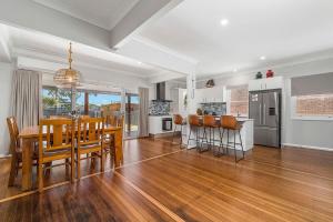 a dining room and kitchen with a table and chairs at Banyandah in North Haven