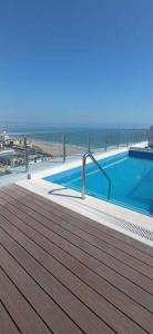 a swimming pool on top of a building next to the beach at MWhite'sHome in Lima