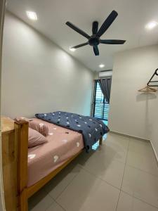 a bedroom with a bed with a ceiling fan at TERATAK QASEH Meru in Kapar +7 photos