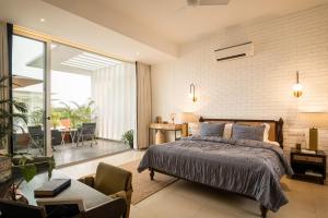 a bedroom with a large bed and a balcony at LaSierra Estate in Mapusa