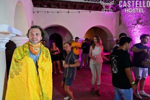 a group of people standing in a room at a party at Ricks hostel Santa Ana in Santa Ana