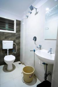 a bathroom with a toilet and a sink at HOTEL PRAKAASH RESIDENCY in Mysore