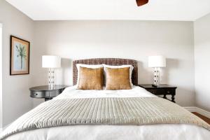 a bedroom with a large bed with two lamps at Gulf Escape in Clearwater Beach