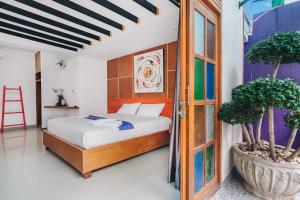 a bedroom with a bed and a window at The Villager Fishermans Village in Bophut 