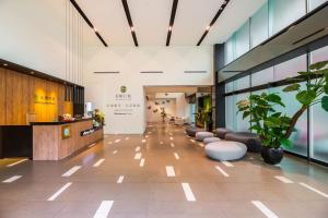 a lobby of a building with a waiting room at Wholesome Hotel in Taipei