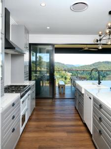 a kitchen with white counters and a large window at Fletchers Ridge - Main House in Montville
