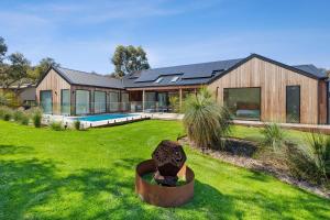 a large house with a yard with a house at Moggs Creek Luxury Escape in Aireys Inlet
