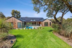 a home with a large yard with a house at Moggs Creek Luxury Escape in Aireys Inlet