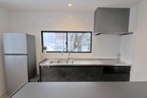 Kuchyň nebo kuchyňský kout v ubytování Myoko Apartments