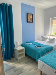 Ένα ή περισσότερα κρεβάτια σε δωμάτιο στο Apartamenty Jeanette