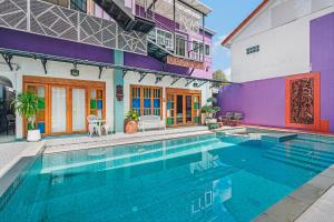 a swimming pool in front of a building at The Villager Fishermans Village in Bophut