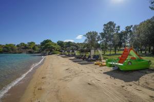 a beach with a row of boats on it at Serenity Estate in Ormos Panagias