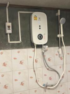 a shower in a bathroom with a camera on the wall at Artist Homestay in Ko Yao Noi