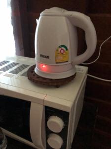 a tea kettle sitting on top of a microwave at Artist Homestay in Ko Yao Noi