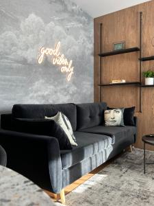 a living room with a couch and a sign that reads good which only at Apartament Rzeszów in Rzeszów +21 photos