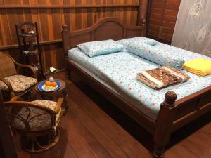 a bedroom with a bed and a table and chairs at Artist Homestay in Ko Yao Noi