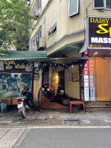 a motorcycle parked in front of a building at Migo Housing 1 - Beer Street - Old Quarter in Hanoi