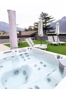 a jacuzzi tub on a patio with chairs at La Villa - Luxury Guest House in Trento