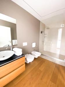 a bathroom with two toilets and a sink at La Villa - Luxury Guest House in Trento