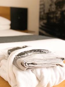 a pile of towels sitting on top of a bed at La Villa - Luxury Guest House in Trento