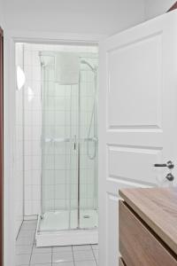 a bathroom with a shower with a glass door at Marina Hotel Lofoten in Svolvær