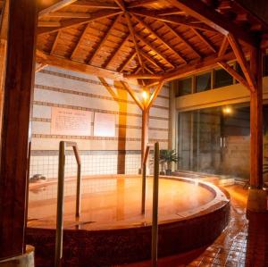 a pool in a building with a wooden floor at Kobe Hotel Fruit Flower in Kobe