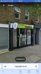 a store front with at Cozy 4 Bed Flat in Islington London in London