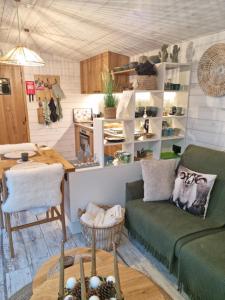 a living room with a couch and a table at LAC ABANE AU LAC in Butgenbach