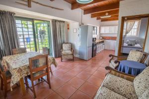 a kitchen and living room with a table and chairs at Koo Karoo Guest Lodge and Self Catering in Montagu