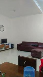 a living room with two brown couches and a table at Villa MountView No 88 Berastagi View in Berastagi +21 photos
