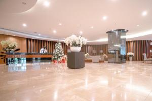 a lobby with a christmas tree and a piano at Tatet Suites Staycation Short Walk to SM MOA in Manila