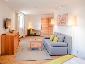 ein Wohnzimmer mit einem blauen Sofa und einem Tisch in der Unterkunft Berghotel Malta in Malta