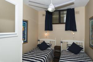 two beds in a room with black and white stripes at The Boulders 304 in Ballito