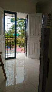 a room with a door and a view of a patio at Villa MountView No 88 Berastagi View in Berastagi