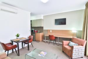 a living room with a couch and chairs and a table at Indulge Apartments - Ontario in Mildura