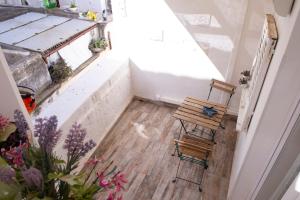 an attic room with a wooden floor and a bench at Casa Nave in Monopoli