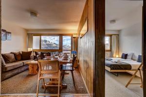 a living room with a table and a couch at Appartement Mont Parrain 14 in La Tzoumaz +20 photos