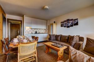 a living room with a couch and a table at Appartement Mont Parrain 14 in La Tzoumaz
