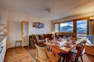 a living room with a table and a couch at Appartement Mont Parrain 14 in La Tzoumaz