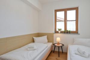 a room with two beds and a window at Ferienwohnung Mibba din in Schwangau