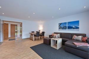 a living room with a couch and a table at Monusse Boid Wohnung 6 in Pfronten