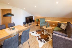 a living room with a couch and a table at Monusse Boid Wohnung 18 in Pfronten