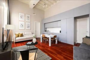 a living room with a couch and a table at Croce Apartments in Rome