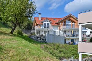 a house on a hill with a stone wall at Ferienwohnung Zugspitze in Pfronten