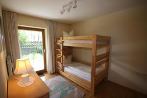 a bedroom with two bunk beds and a table at Ferienwohnung Bärbel in Osterreinen