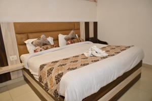 a bedroom with a bed with a stuffed animal on it at Hotel Shine Star By Tag Your Trip Near Golden Temple in Amritsar