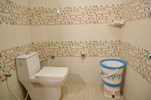 a bathroom with a toilet and a wall covered in tiles at Hotel Shine Star By Tag Your Trip Near Golden Temple in Amritsar