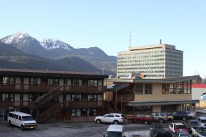 um parque de estacionamento com carros estacionados em frente aos edifícios em The Driftwood Lodge em Juneau