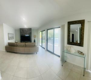 a large living room with a couch and a television at 3 Seacrets at Shelly in Urangan